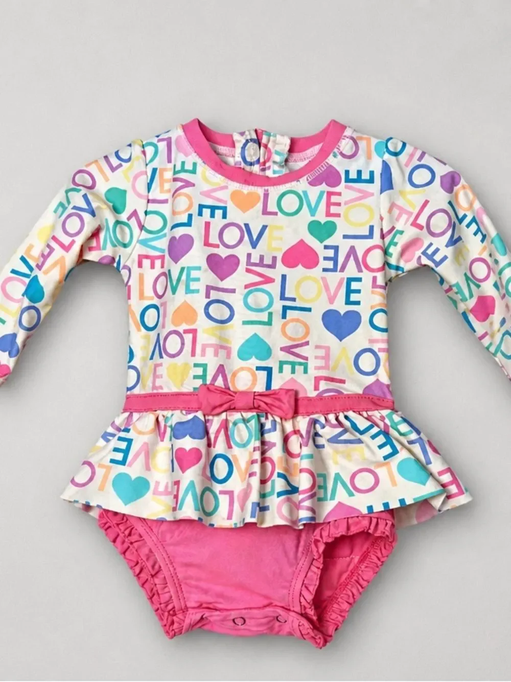 Ruffle Butts pink Love print ruffle bottom one piece rash guard swim-flaw
